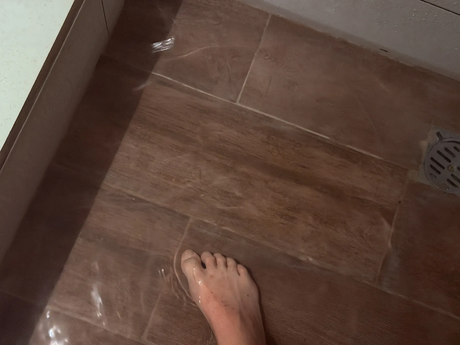 The shower drain that cannot keep up.